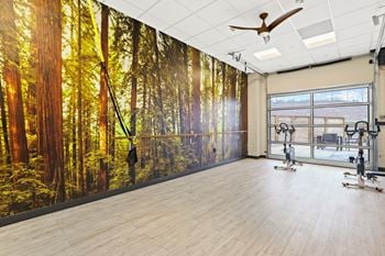 A yoga studio with a large mural of a forest
